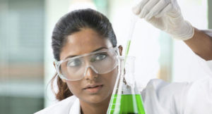 A scientist looking at liquid